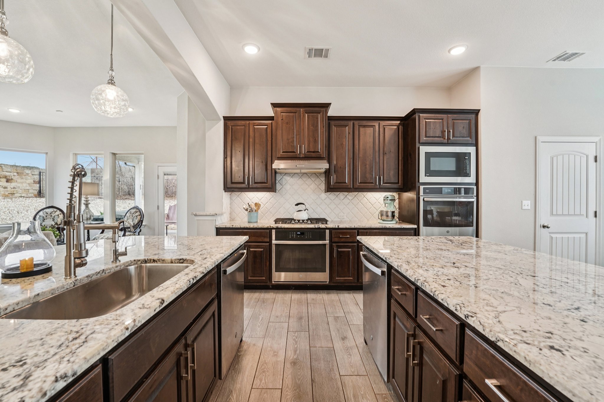 17820 Limestone Spring Lane Austin, TX 78738 - Photo 3 of 35 a kitchen with granite countertop a sink counter top space appliances and cabinets