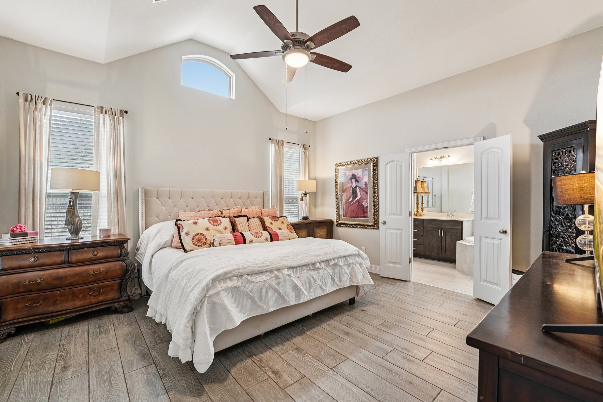 17820 Limestone Spring Lane Austin, TX 78738 - Photo 6 of 35 a bedroom with a large bed a chandelier and dresser