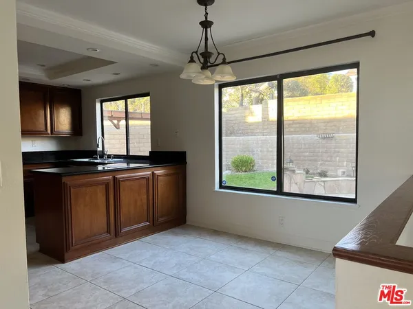 a view of an empty room with a fireplace and a floor to ceiling window