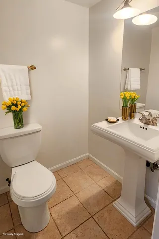 a white toilet sitting next to a bathroom sink
