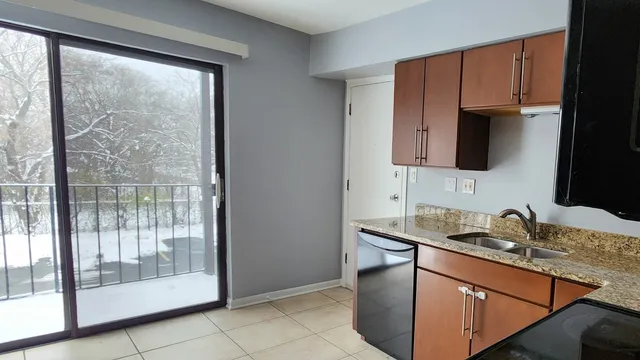 a kitchen with stainless steel appliances granite countertop a sink stove and microwave