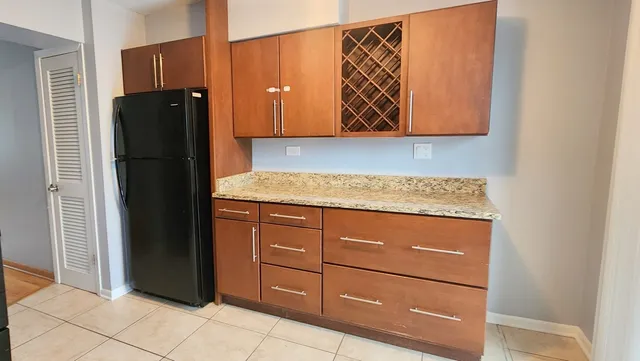 a kitchen with a refrigerator and cabinets