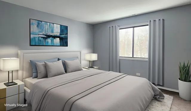 a bedroom with a bed and a painting on the wall