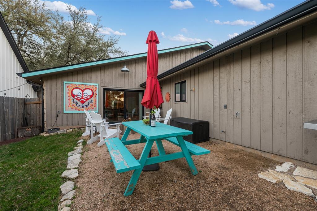 2210 Red Fox Road Austin, TX 78734 - Photo 19 of 40 A quaint backyard patio retreat with a charming picnic table, perfect for unwinding under the open sky.