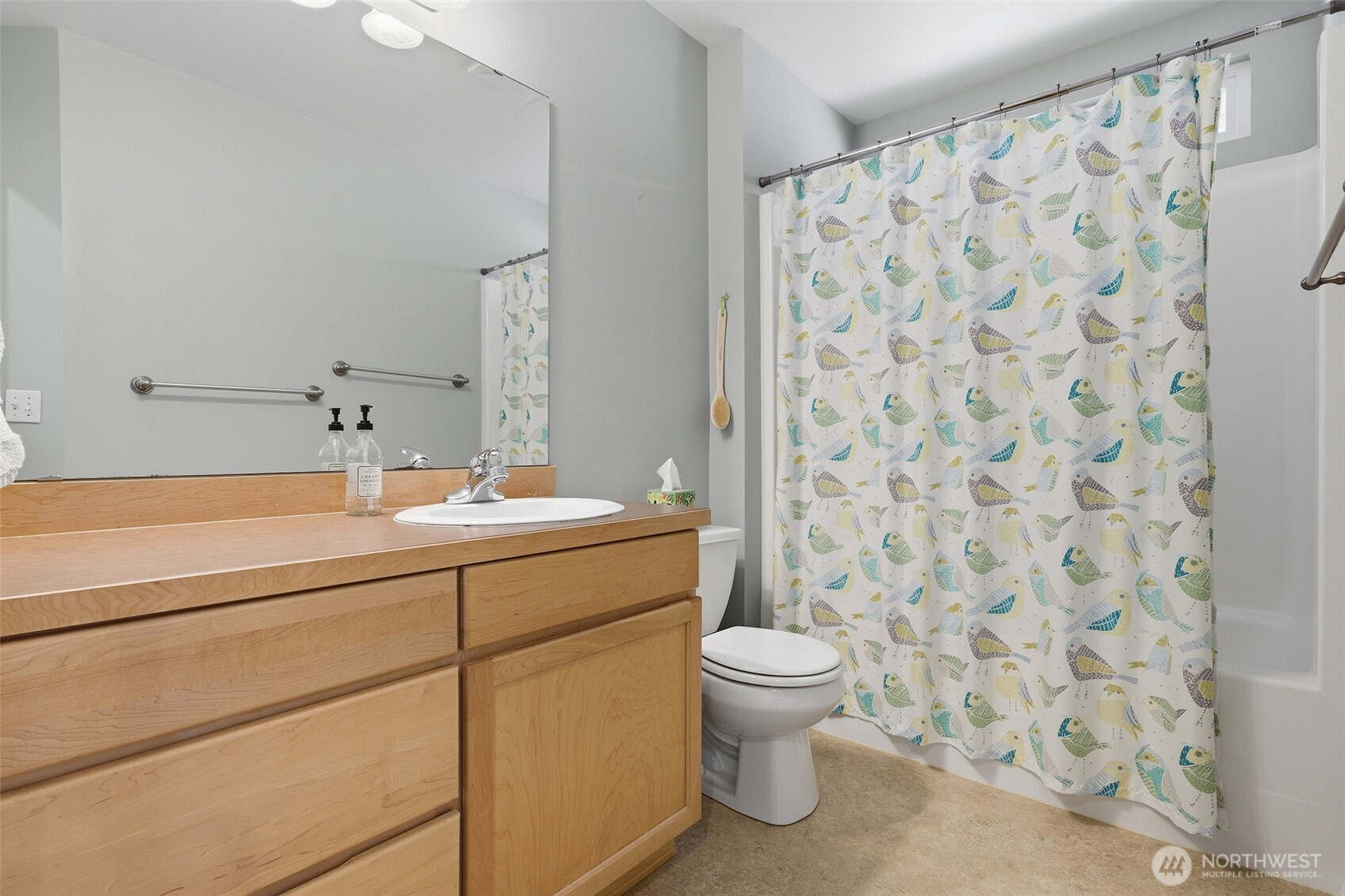 17747 89th Court Northeast Bothell, WA 98011 - Photo 24 of 33 a bathroom with a sink a toilet and shower curtain