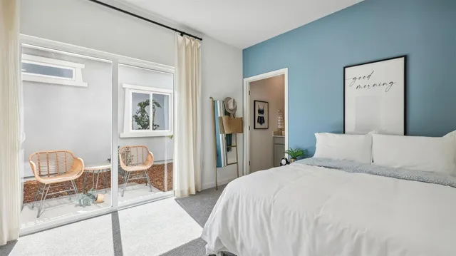 a bedroom with a bed and a chair