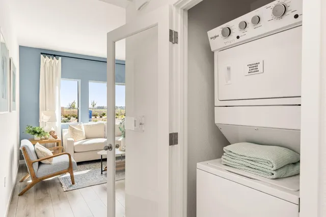 a living room with furniture and a white stove next to a window