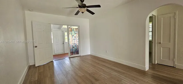 wooden floor in an empty room with a window