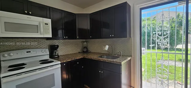 a kitchen with a stove microwave and cabinets