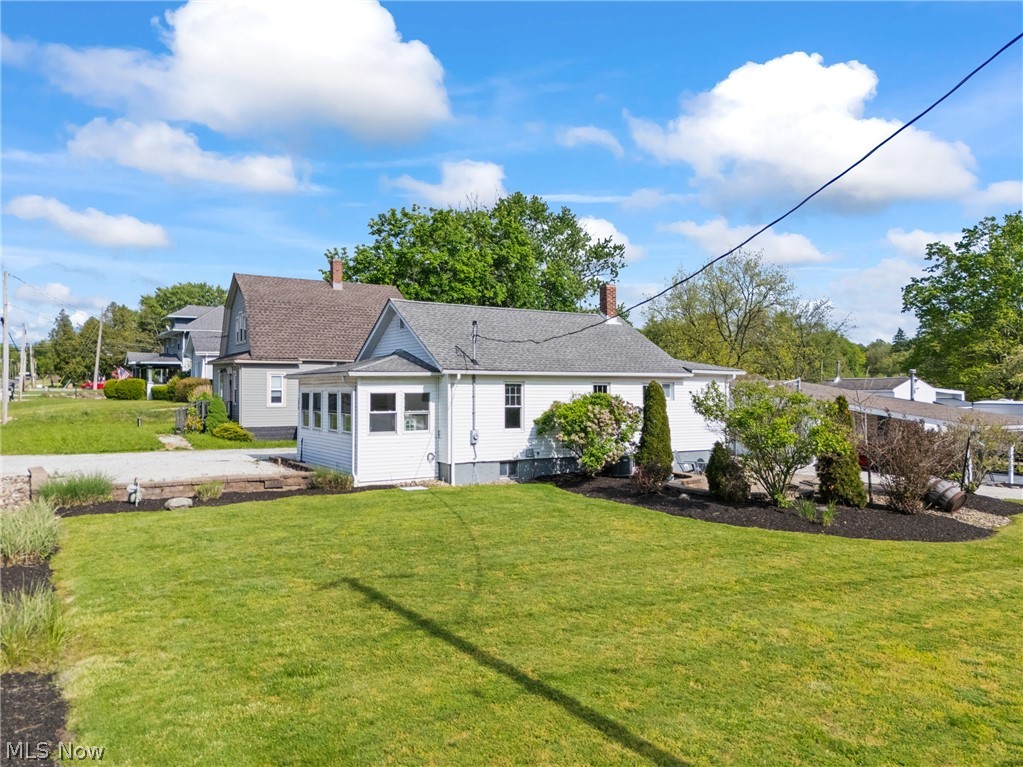 258 Randolph Road Mogadore, OH 44260 - Photo 41 of 49 White exterior with a gable roof and a sunroom addition