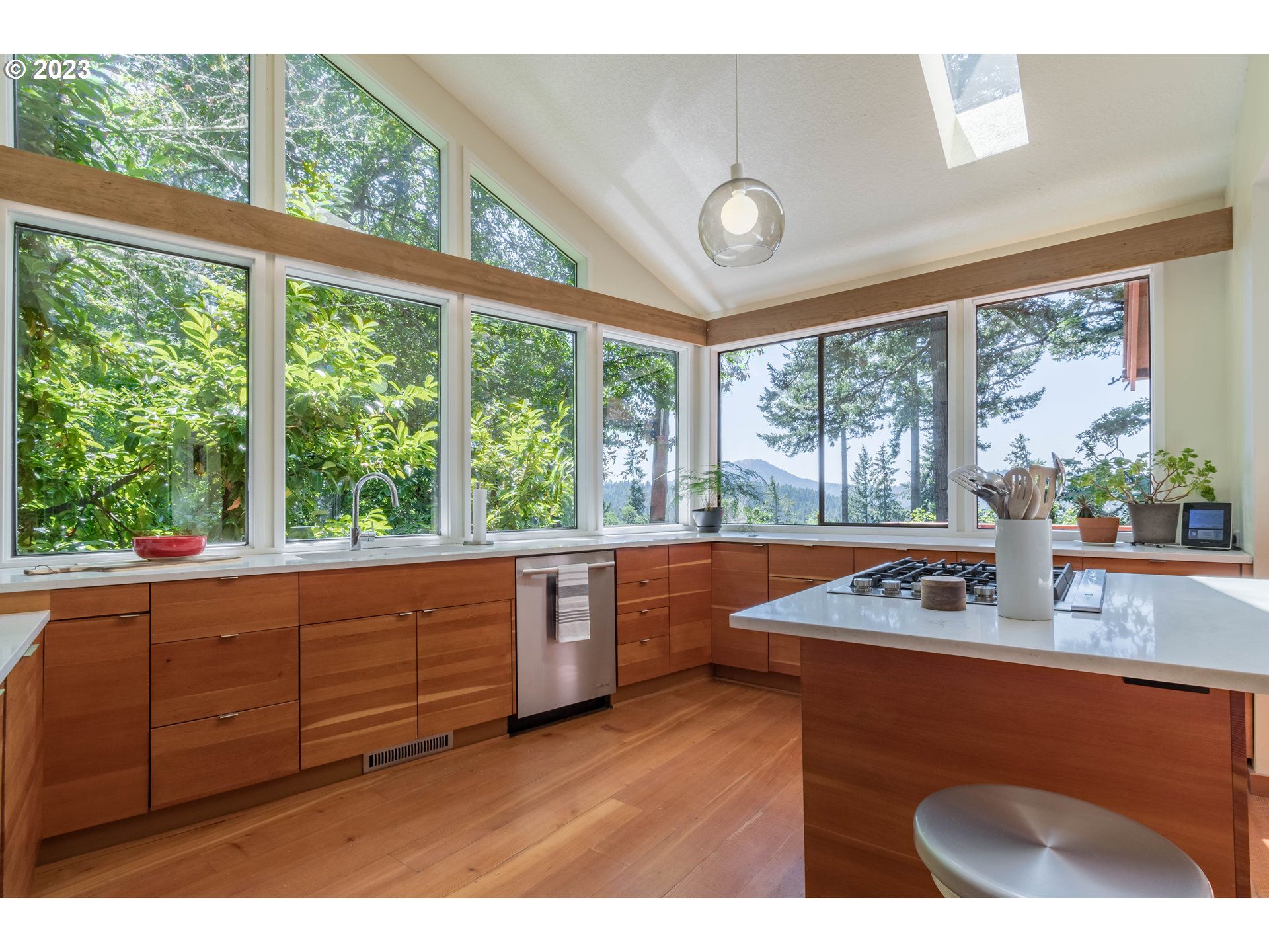 2780 Cresta De Ruta Street Eugene, OR 97403 - Photo 11 of 48 a kitchen with wooden cabinets a sink a large window and a bed