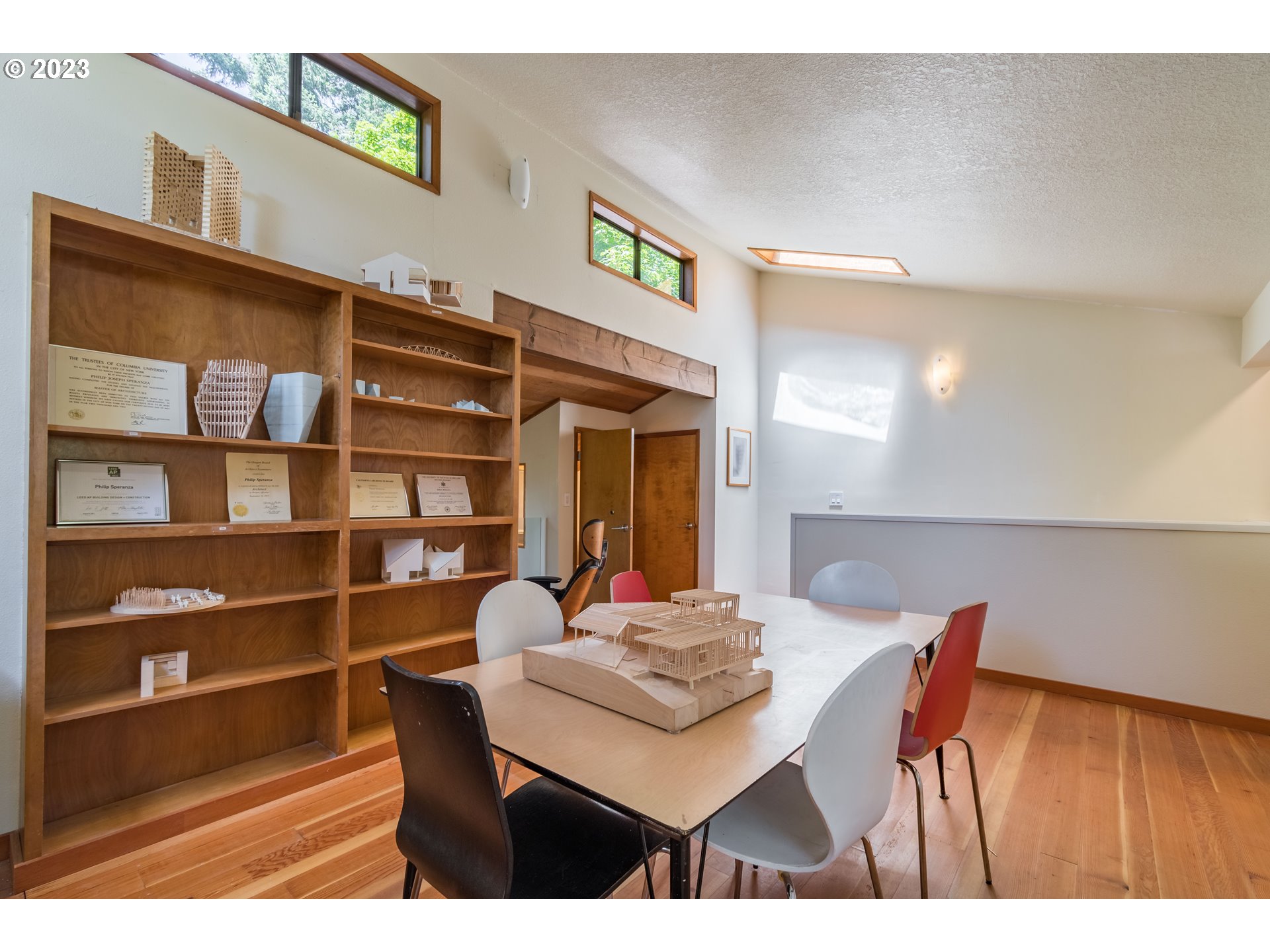2780 Cresta De Ruta Street Eugene, OR 97403 - Photo 35 of 48 a view of a dining room with furniture and a book shelf