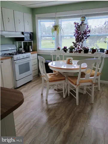 a kitchen with a table and chairs in it