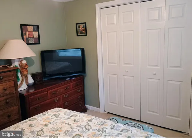 a room with a bed and a television