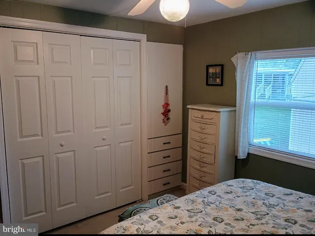 a bedroom with a dresser and a window