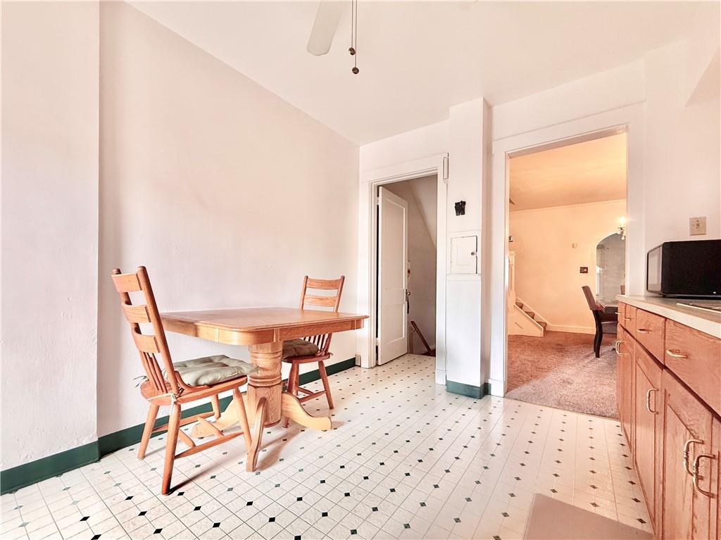 3232 California Avenue Pittsburgh, PA 15212 - Photo 11 of 38 a living room with furniture a flat screen tv and a table