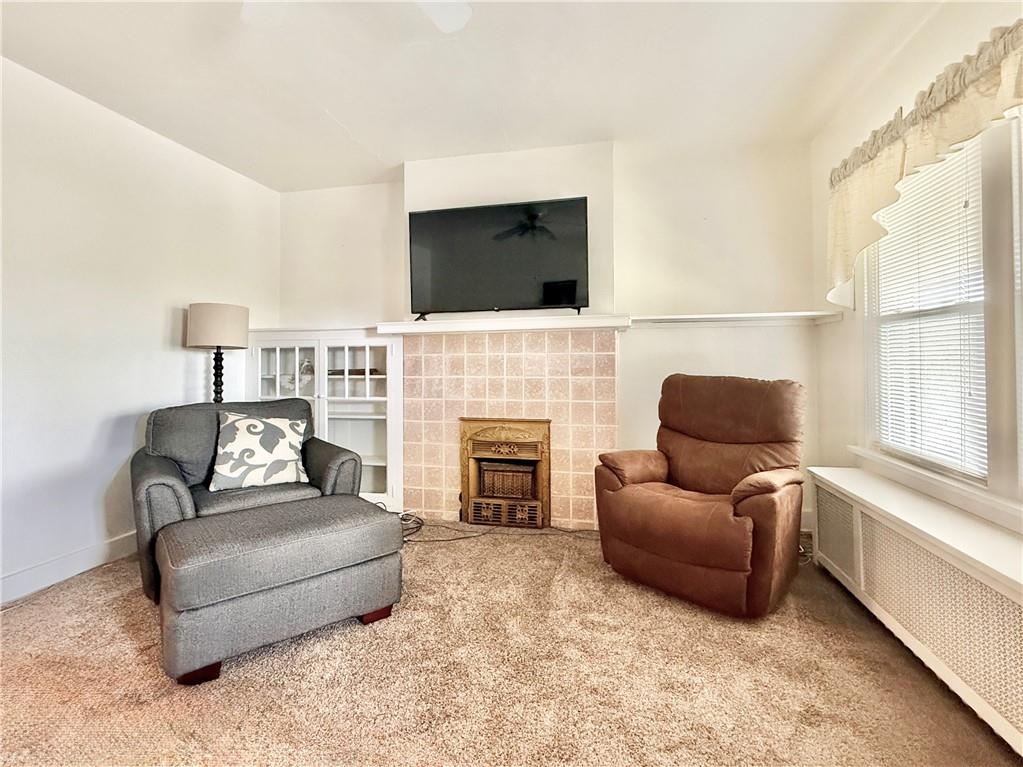3232 California Avenue Pittsburgh, PA 15212 - Photo 4 of 38 a living room with furniture flat screen tv and a fireplace
