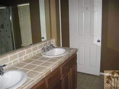 67698 Rio Arapaho Road Cathedral City, CA 92234 - Photo 6 of 11 a bathroom with a sink and a mirror