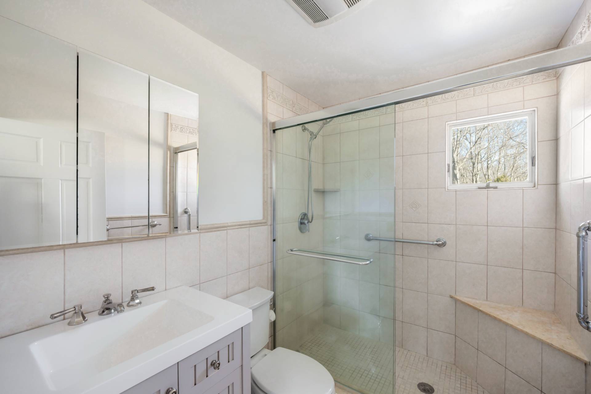 20 Ridge Road West Sag Harbor, NY 11963 - Photo 8 of 12 a bathroom with a sink mirror and toilet