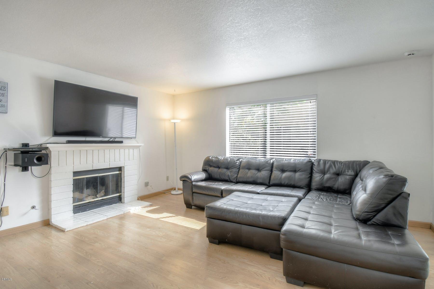 430 Percy Street Oxnard, CA 93033 - Photo 3 of 35 a living room with furniture a flat screen tv and a fireplace