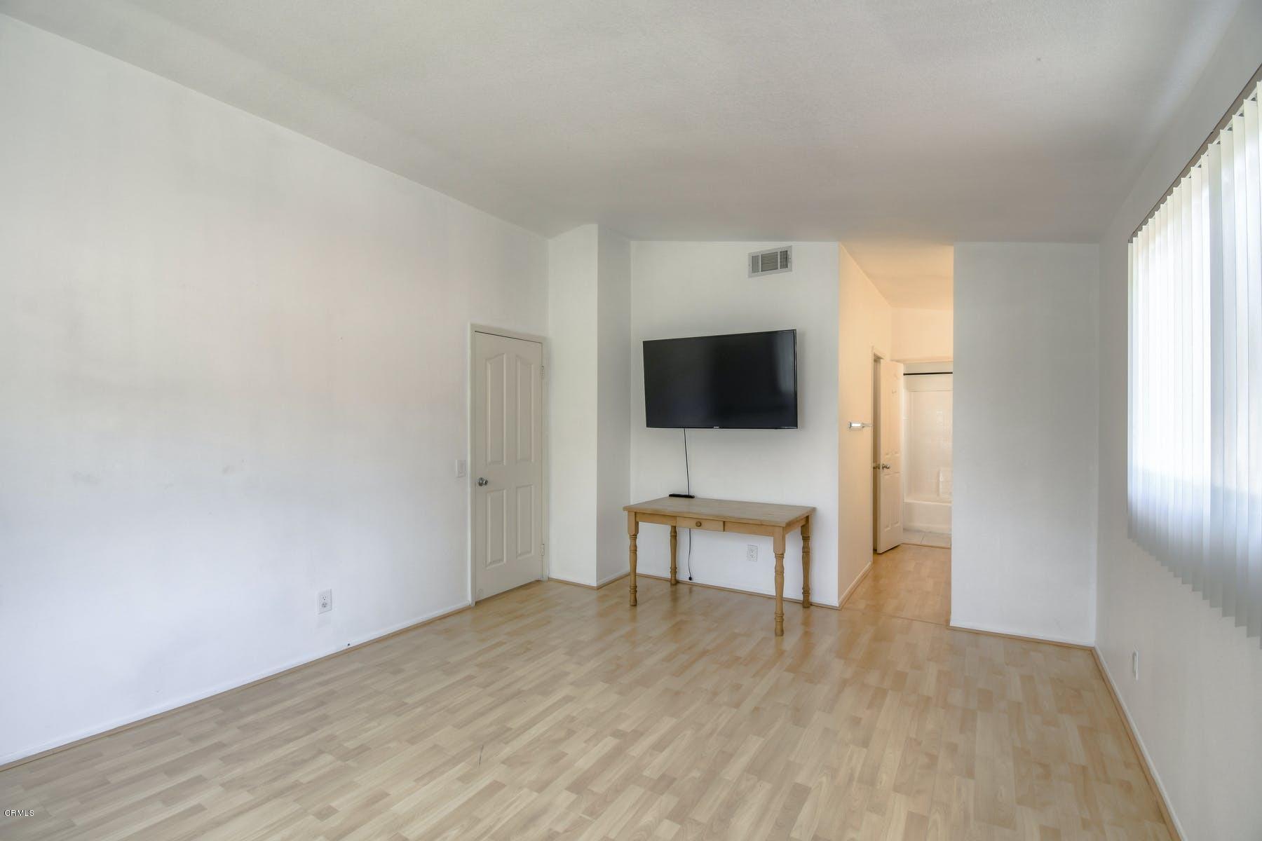 430 Percy Street Oxnard, CA 93033 - Photo 22 of 35 a view of a livingroom with wooden floor and a flat screen tv