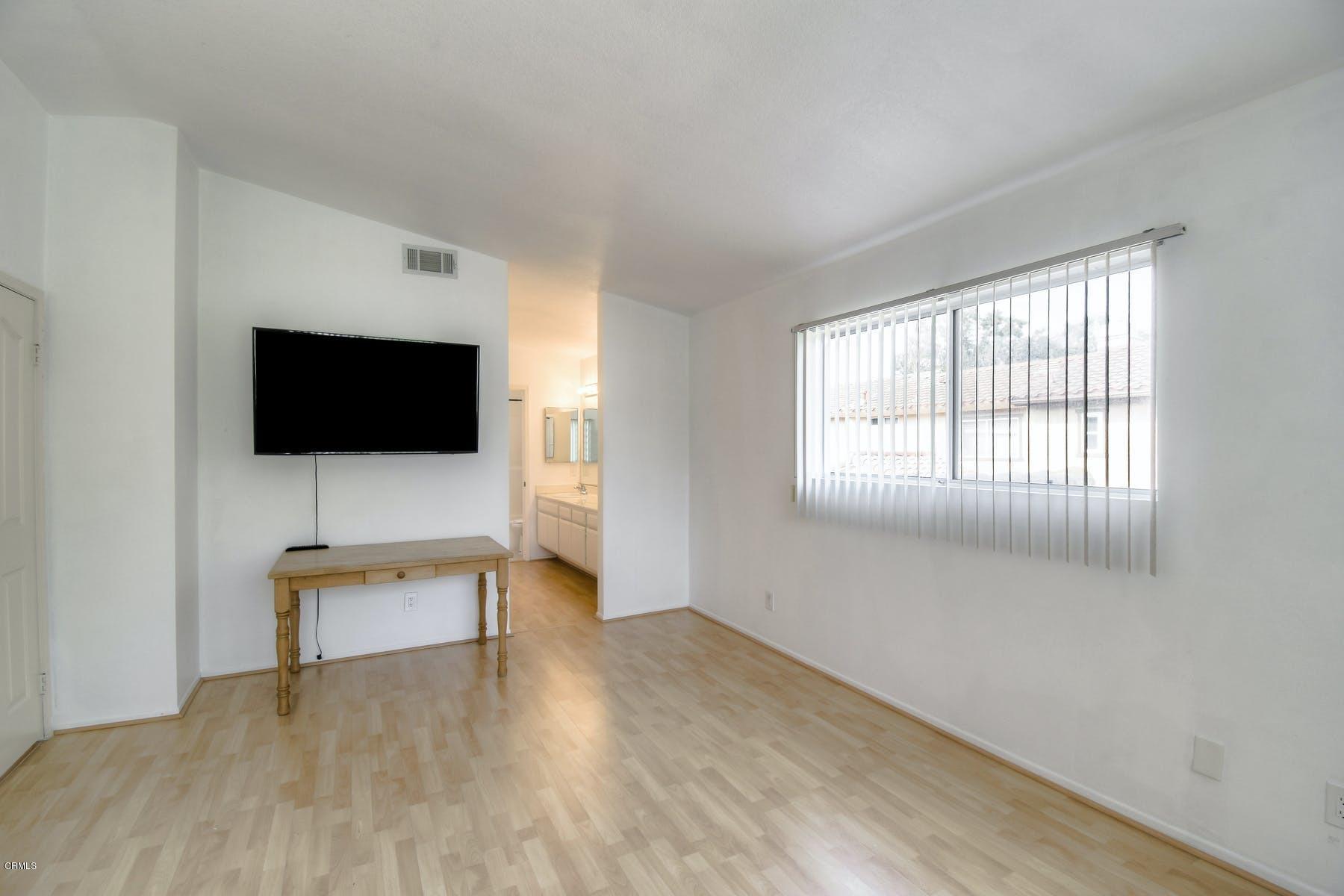 430 Percy Street Oxnard, CA 93033 - Photo 23 of 35 a living room with a flat screen tv a lamp and a window