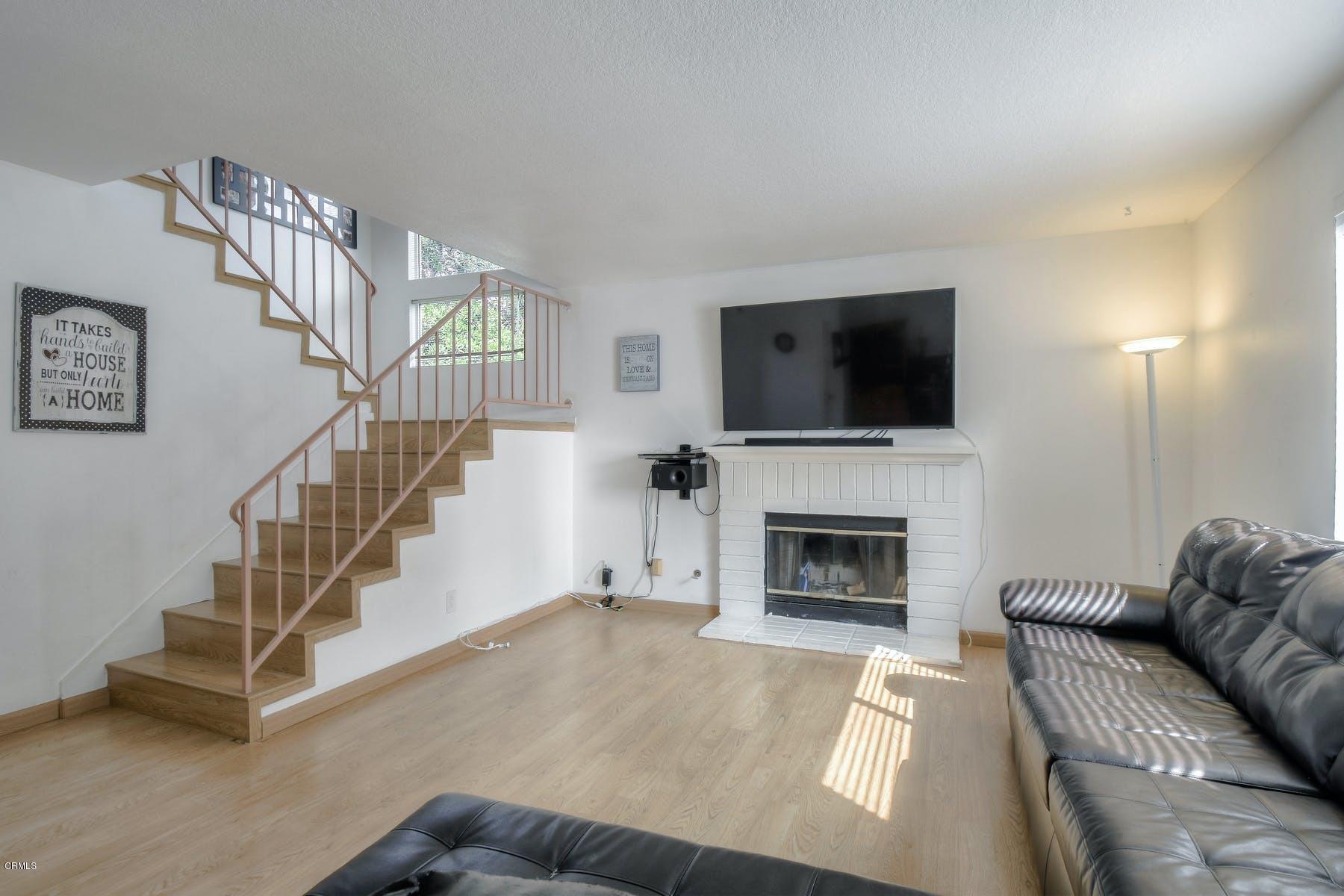 430 Percy Street Oxnard, CA 93033 - Photo 4 of 35 a living room with furniture a fireplace and a flat screen tv