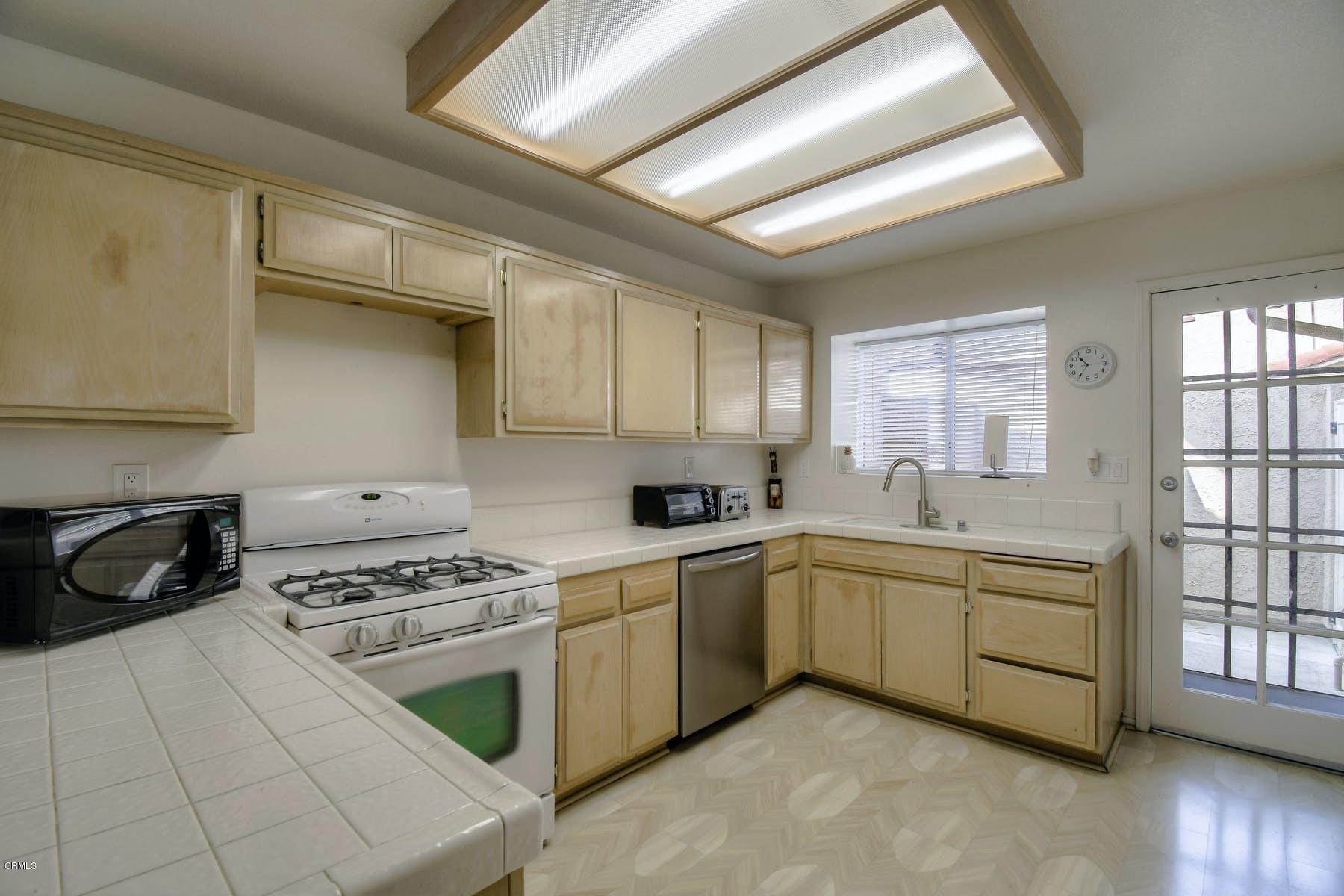 430 Percy Street Oxnard, CA 93033 - Photo 6 of 35 a kitchen with a stove a sink and cabinets