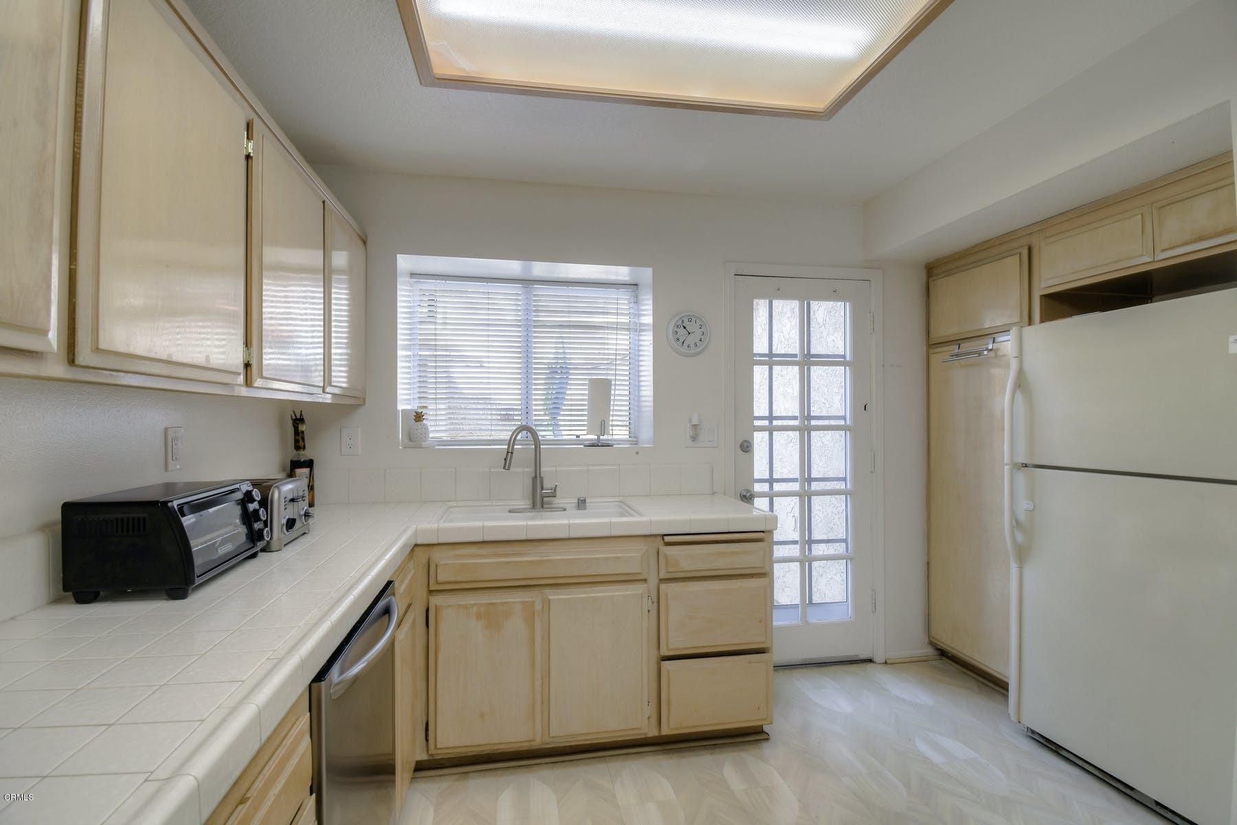430 Percy Street Oxnard, CA 93033 - Photo 7 of 35 a kitchen with a refrigerator sink and cabinets