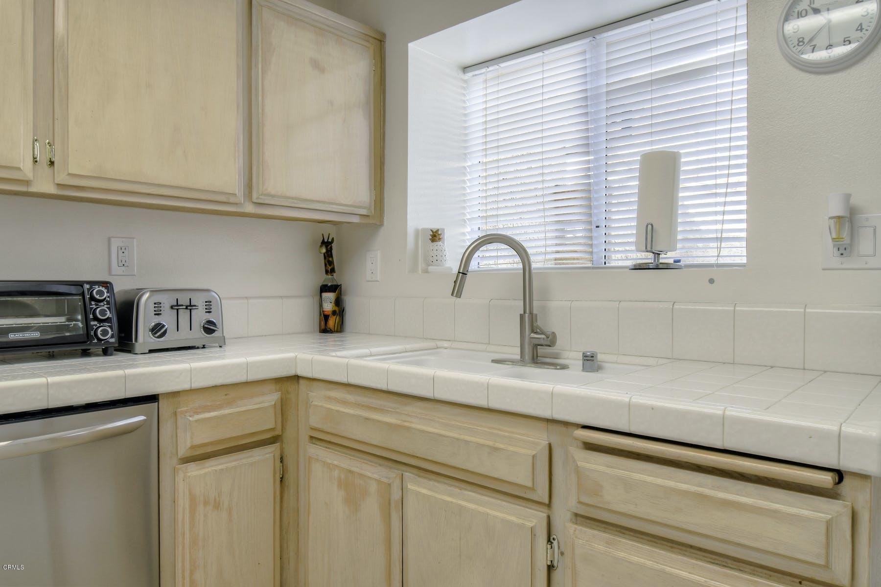 430 Percy Street Oxnard, CA 93033 - Photo 10 of 35 a kitchen with stainless steel appliances granite countertop white cabinets a sink and dishwasher