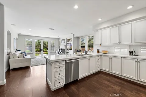a kitchen with cabinets a sink and appliances