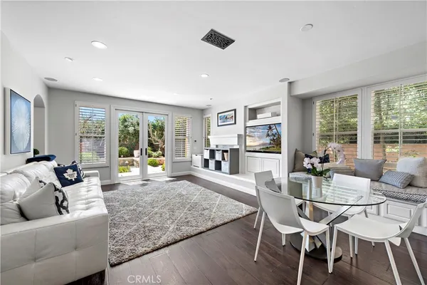 a living room with furniture and a floor to ceiling window