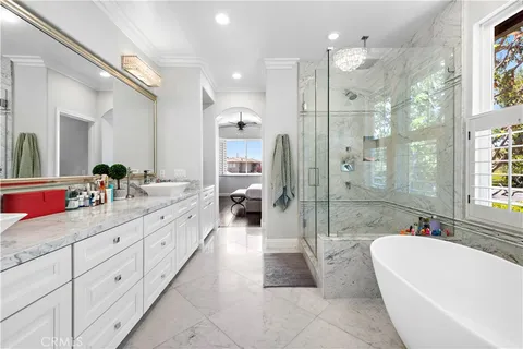 a spacious bathroom with a tub sink shower and mirror