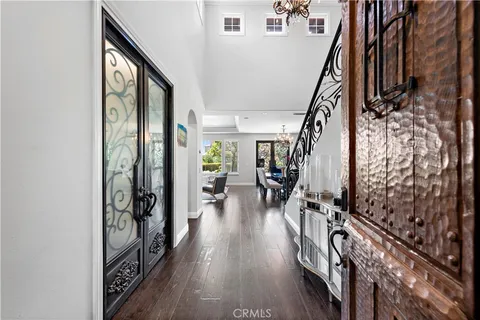 a view of an entryway with wooden floor and stairs