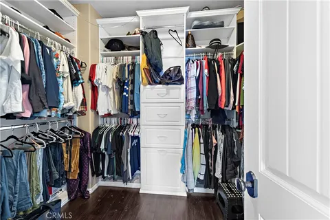 a view of walk in closet with clothes