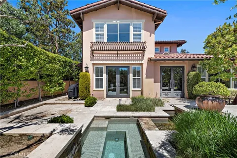 a view of a house with sitting area and garden
