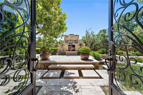 a view of a patio with couches table and chairs and potted plants
