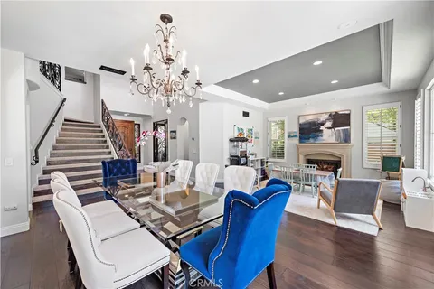 a living room with fireplace furniture and a chandelier