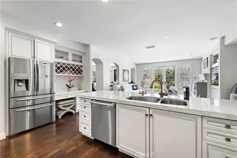a kitchen with sink a microwave and refrigerator