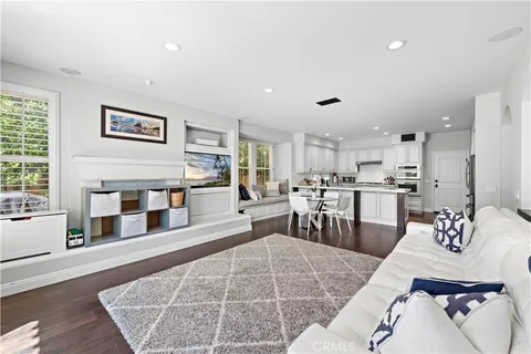 a living room with furniture and kitchen view