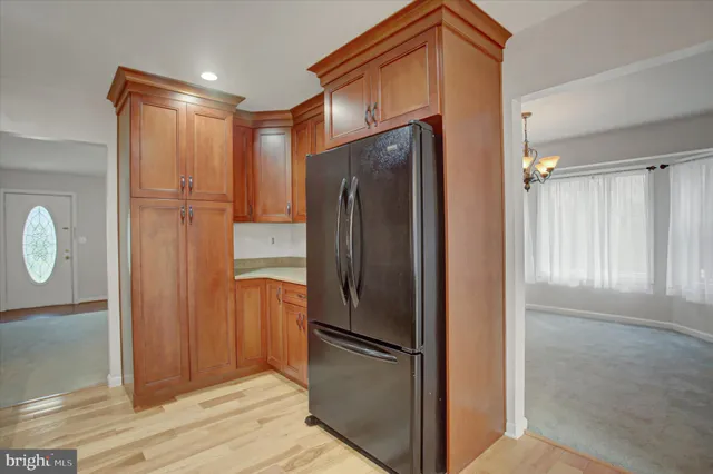a metallic refrigerator freezer sitting in a kitchen