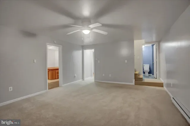 an empty room with a chandelier fan