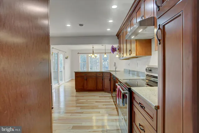 a kitchen with stainless steel appliances granite countertop a sink and cabinets