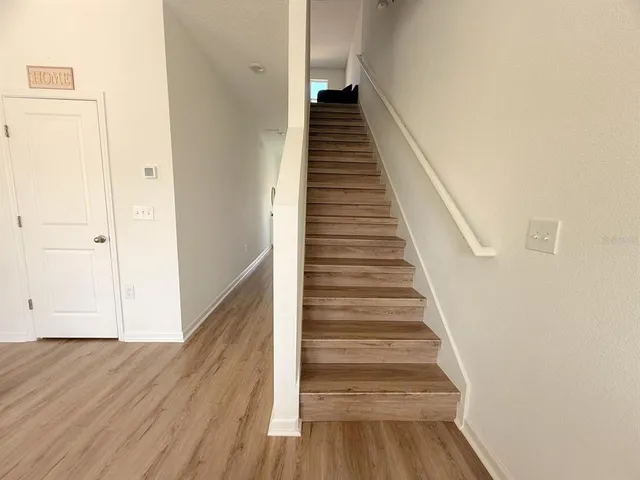 a view of entryway and gallery with wooden floor