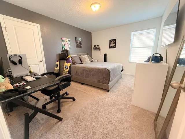 a living room with furniture a window and a flat screen tv