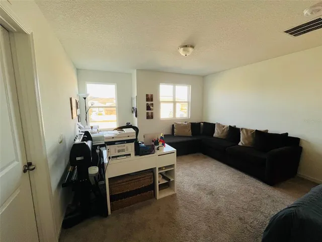 a bedroom with two beds and a lamp