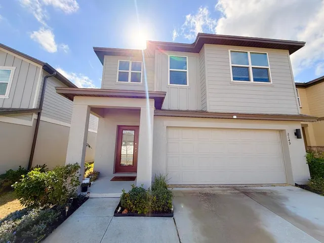 a view of a house with potted plants