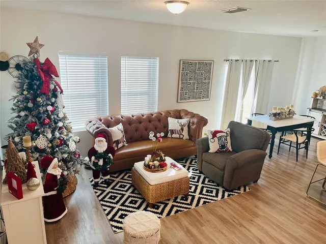a living room with furniture and a potted plant