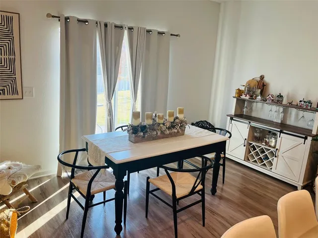 a view of a dining room with furniture and wooden floor