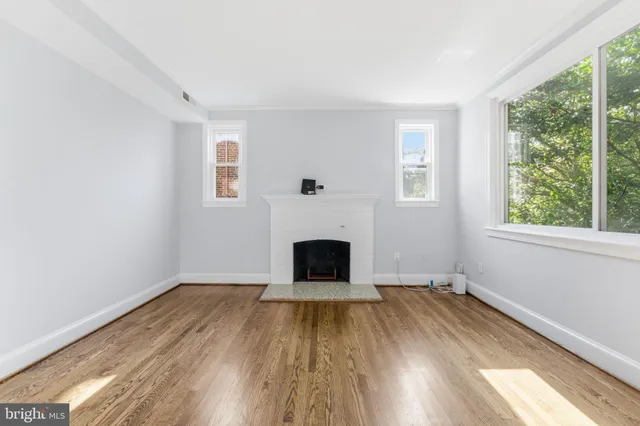a kitchen with cabinets stainless steel appliances a sink and wooden floor
